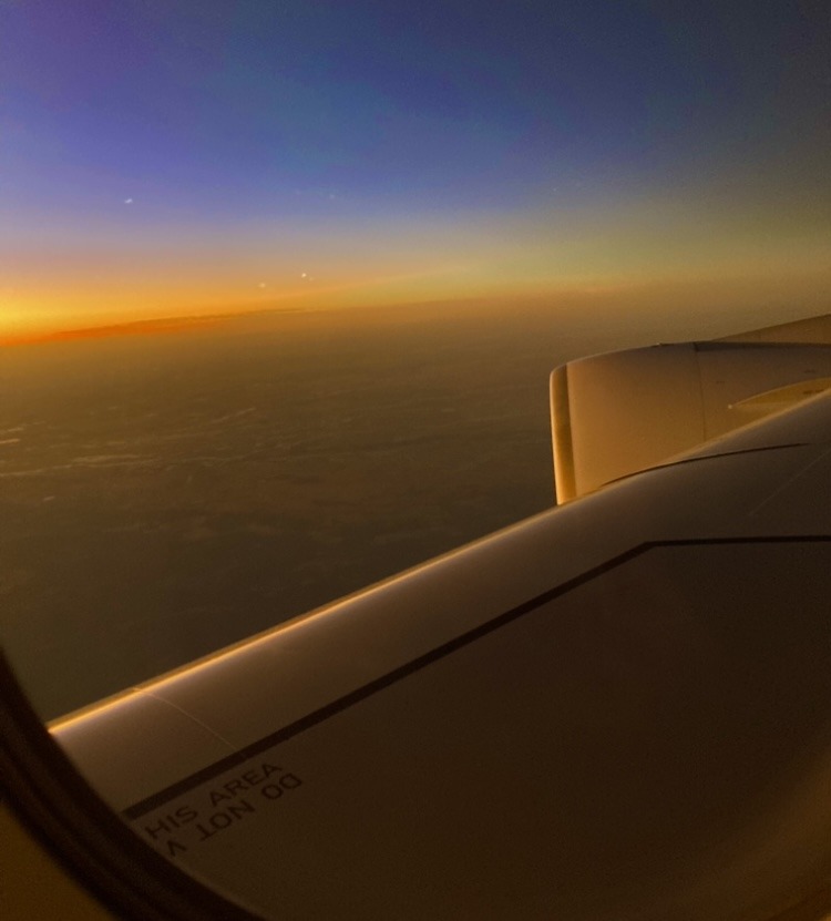 wing on an aeroplane with sunrise in background