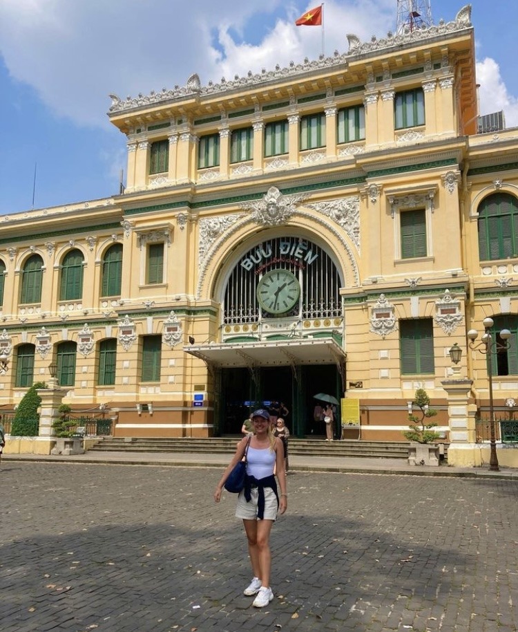 yellow brick building with girl standing in front