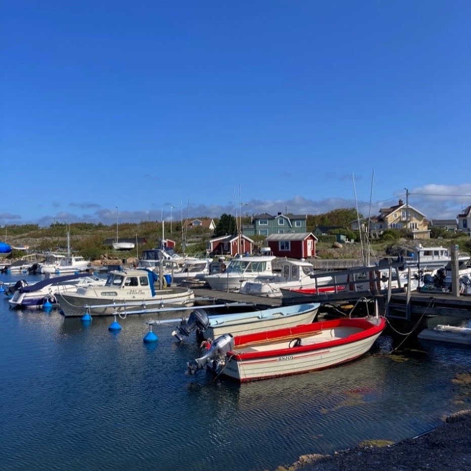 harbour with small red boats and bright blue sky