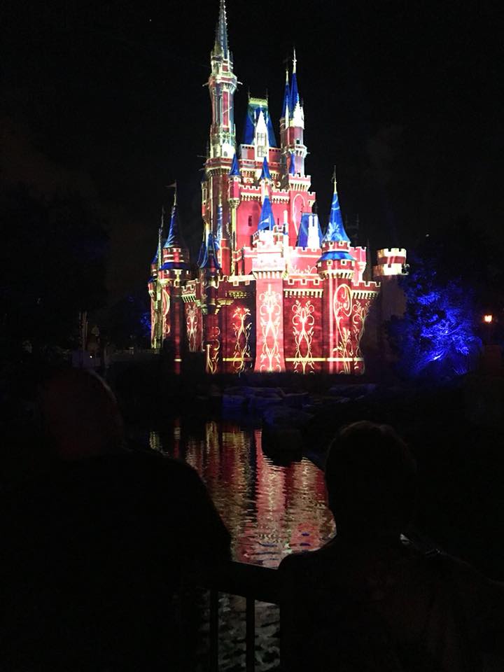 castle with red and gold projection on it